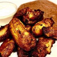 Platanos Con Frijoles Y Crema · Fried banana with beans and cream.