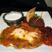 Huevos Rancheros · Frijoles, chorizo y crema. Beans, chorizo and cream.