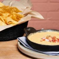 Warm Queso · Housemade queso, green chile, pico, chips