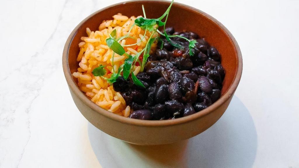 Arroz Rojo Y Frijoles · carrots, onions, red rice, sofrito black beans, queso fresco