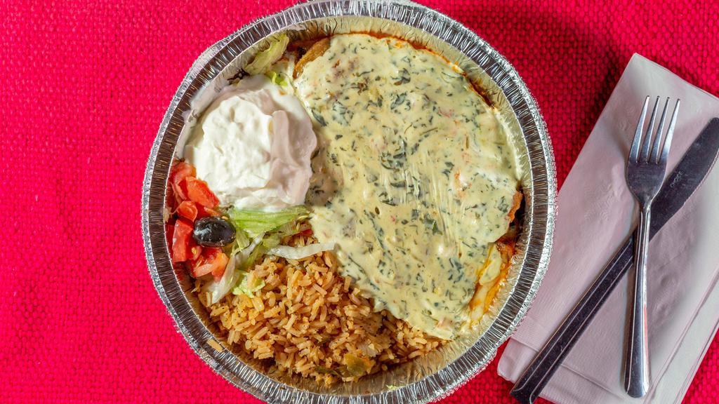 Spinach Enchilada Dinner · Two corn tortillas stuffed with spinach blend, covered with our delicate tomato sauce & topped with zesty cheese sauce, served with sour cream and rice.