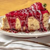Brulee Cheesecake  · A homemade rich and creamy baked cheesecake, glazed in a luscious cream, and raspberry sauce.