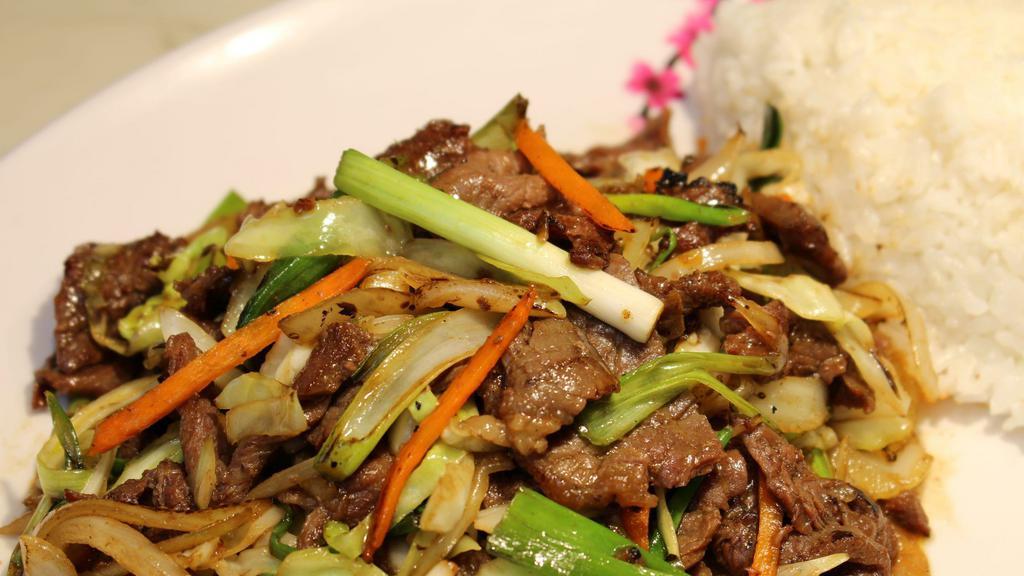 Mongolian Beef · Marinated slices of tenderized beef stir-fried with onions and green onions.