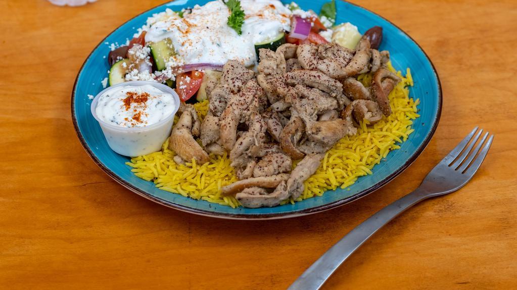 Chicken Shawarma Plate · Grilled chicken shawarma drizzled with our homemade tzatziki sauce served with a bed of basmati rice and Greek salad.