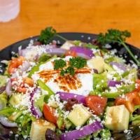 Greek Salad · A traditional Greek classic made with romaine lettuce, tomatoes, cucumbers, onions, kalamata...