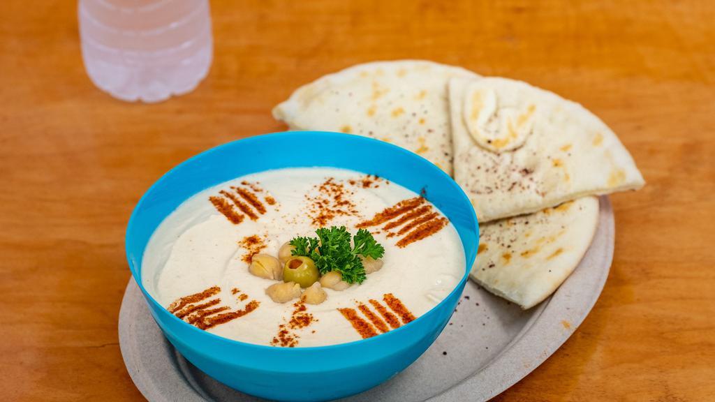 Hummus Plate · A smooth mix of mashed garbanzo beans, tahini, lemon, garlic, and olive oil. Served with pita bread.