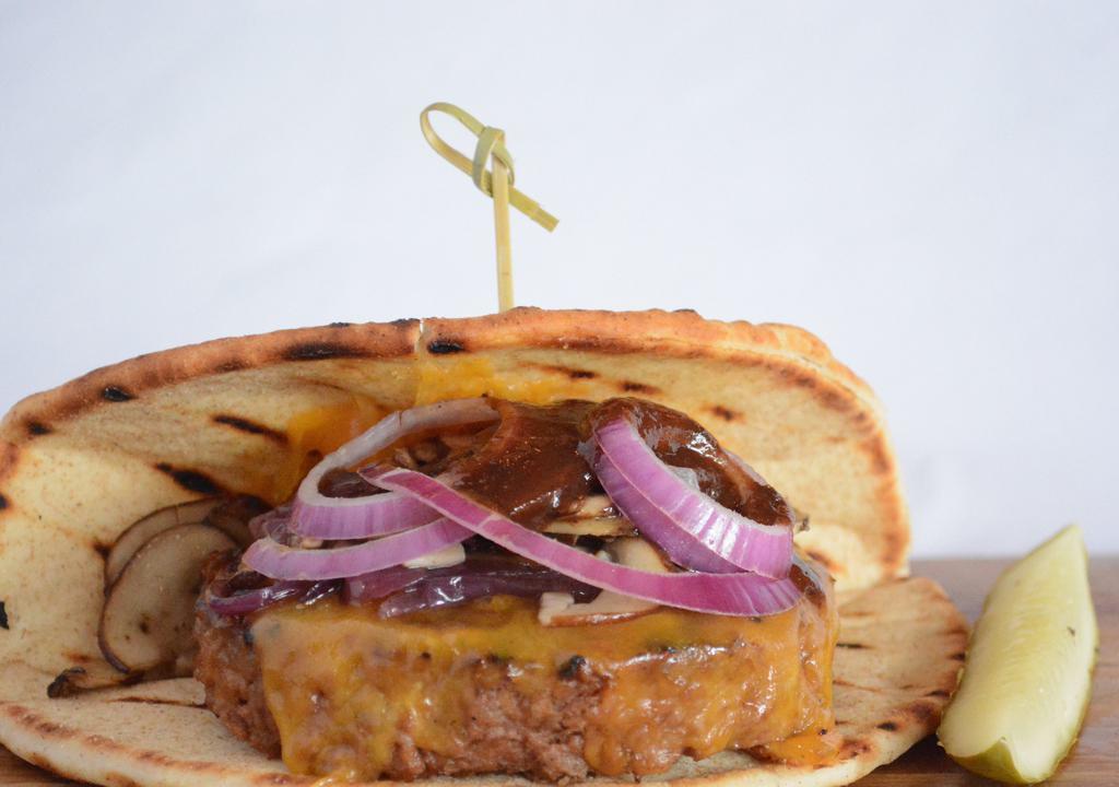 Vegan Onion & Mushroom Burger · Beyond patty topped with vegan cheddar, red onions, mushrooms and A1 steak sauce on vegan flatbread.