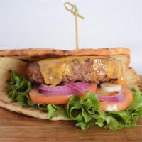 Vegan All American Burger · Beyond patty topped with vegan cheddar, tomato, red onion, lettuce and pickles on vegan flat...