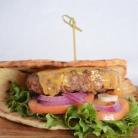 Vegan Classic Burger · Beyond patty topped with tomato, red onion, lettuce and pickles on vegan flatbread.