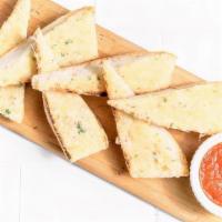 Parmesan Bread · Rustic baguette toasted with herb-garlic butter and parmesan, side of marinara sauce.