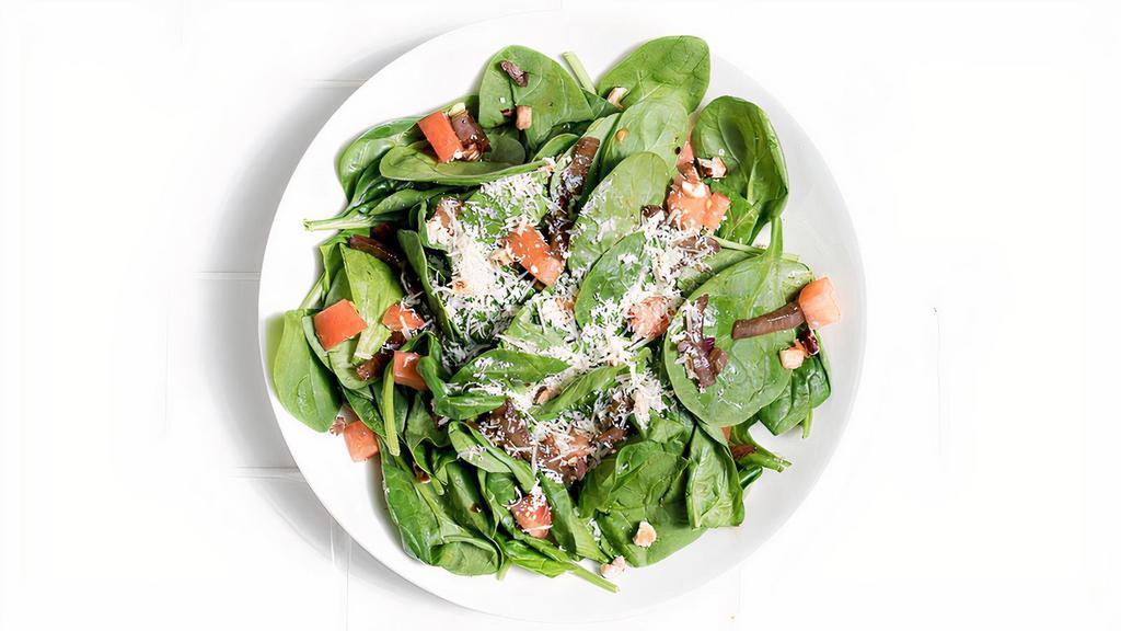 Spinach Salad Balsamico · Roasted balsamic onions, fresh tomato, parmesan, hazelnuts, balsamic-red wine vinaigrette.