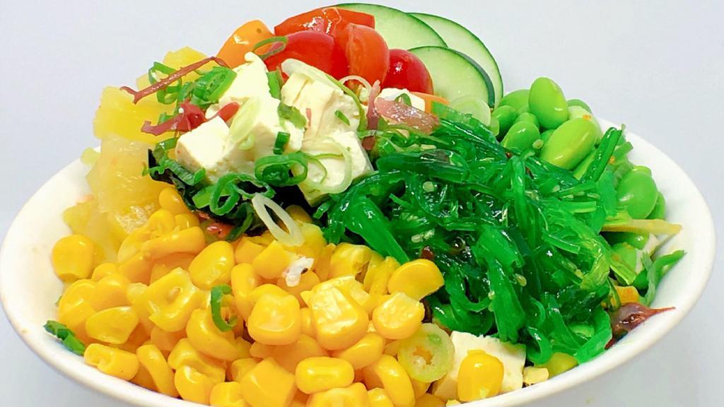 Buddha Bowl · Fried tofu, green onion, seaweed, salad mix, seaweed salad, edamame, corn, tomato, pineapple, cucumber.