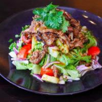 Bbq Beef Salad · Grilled marinated beef with lime juice, fresh chilies, onions, tomatoes, cucumber, on a bed ...