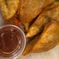 Fried Wontons (7) · Deep fried wonton warp with ground chicken and vegetables served with sweet and sour sauce.