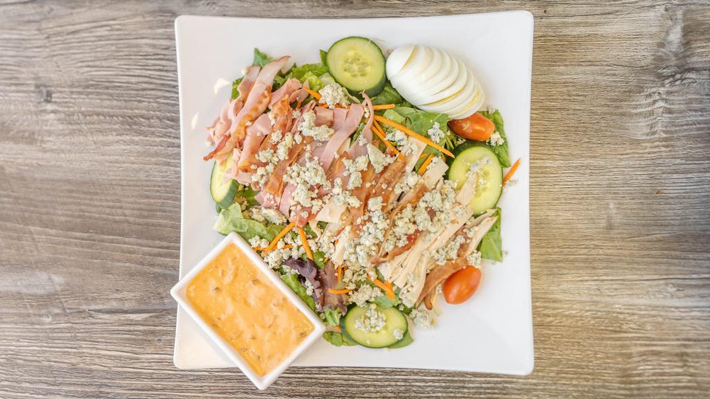 City Cobb · Mixed greens, turkey, ham and bacon, carrots, tomato, cucumber, bleu cheese crumbles, hard-boiled egg and thousand island dressing.