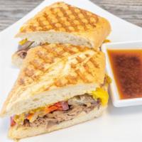 French Dip · Roast beef, cheddar cheese, pepperoncini's, sautéed peppers and onions and horseradish on Fr...