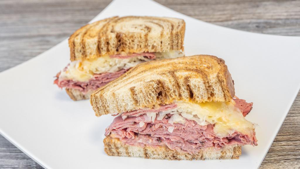 Reuben · Pastrami, corned beef or turkey, swiss cheese, sauerkraut, thousand island dressing and pickle spear, on toasted marble rye.
