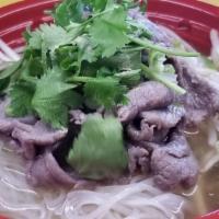 Beef Noodle Soup (Pho) · Sliced beef, rice noodle, bean sprout, garnish in beef broth.