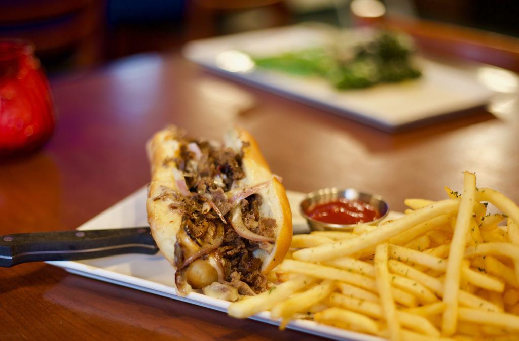 Gol Cheesy Philly Steak · 6oz flank steak with sautéed vegetables  and topped with provolone cheese on a hoagie roll served with fries or salad.