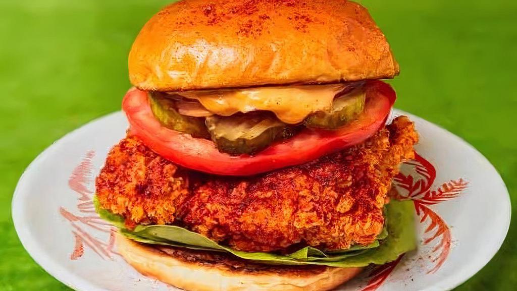 Spicy Fried Chicken Sandwich · Spicy crispy chicken breast with tomato, lettuce, onion, pickles, and house sauce.
