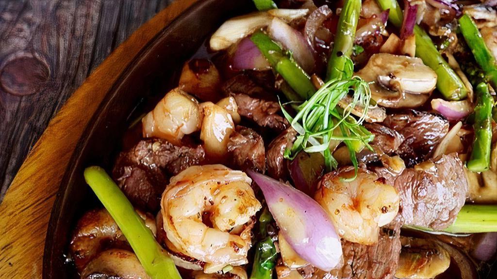 Surf & Turf · sliced flat iron steak, shrimp, asparagus, onions, mushrooms, thai basil