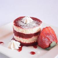 Decadent Red Velvet Cake · Red velvet cake layered with delicious cream cheese frosting topped with whipped cream.