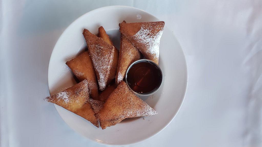 Sopapilla Basket · Fried pastry coated with cinnamon and sugar and served with a honey dipping sauce.