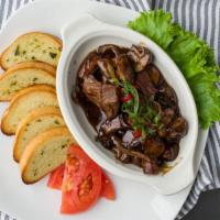 Steak Tips · Sauteed Steak Tips with mushrooms and onions in a demi glaze served with a side of garlic to...