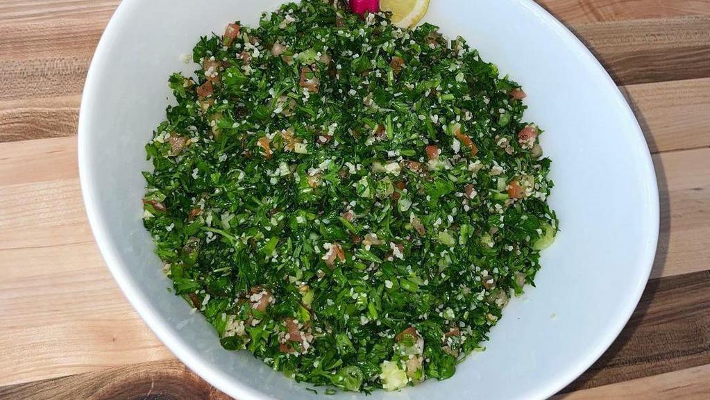 Tabouleh Salad · Served with diced tomatoes, onions, parsley, mint, and tossed wheat bulgur.