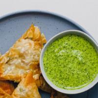 Vegetable Samosa (Vegan) · Savory deep fried pastry puffs filled with mildy spiced potato and peas.