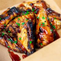 Huli Huli Wings · Grilled chicken wings marinaded in our Huli Huli sauce topped with scallions