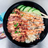 Kalua Pork · Slow cooked smoky pork shoulder over rice with cucumber, sesame seeds topped with spicy mayo.