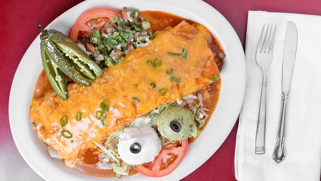 Carne Asada Burrito Muy Grande · Large flour tortilla stuffed with rice & beans, charbroiled top sirloin steak sauteed mushrooms & onion topped with special sauce, garnished with pico de gallo guacamole, sour cream and one jalapeño fried 