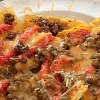Hot Cheeto Nachos · Hot Cheeto chips topped with nacho cheese, ground beef, pinto beans, tomatoes, onions and so...