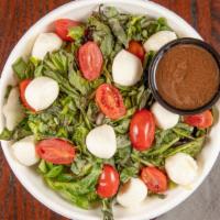 Tossed Caprese · Mixed greens, cherry tomatoes, fresh small mozzarella cheese balls, shredded basil and our h...
