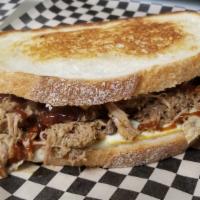Grilla Pork · Tender slow-cooked pork, shredded, grilled and placed in a grilla cheese with a splash of BB...