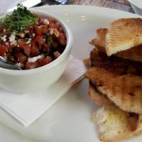 Bruschetta · bread from the grill drizzled with olive oil and served with Mediterranean tomato-caper salsa
