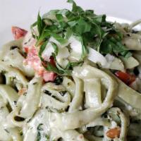 Genoa · basil cream sauce with fresh tomato, toasted pine nuts, and a hint of garlic over spinach fe...