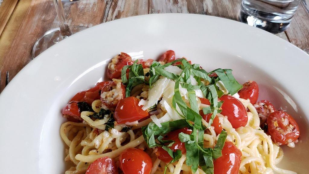 Vesuvio · lots of fresh minced garlic sautéed in olive oil and tossed with red chile, fresh tomato, basil, and house-made linguine. Spicy - mild upon request