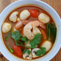 Tom Yum Soup · Cabbage, onions, mushrooms, tomatoes, with cilantro on top.
