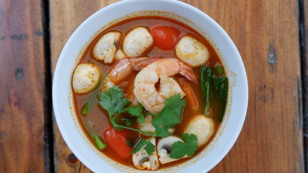 Tom Yum Soup · Cabbage, onions, mushrooms, tomatoes, with cilantro on top.