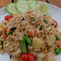 Pineapple Fried Rice · Onions, peas, carrots, pineapple, raisins, and cashews, topped with cucumber, tomato, and ci...