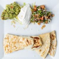 Quesadilla  · choice of beef or chicken served with guacamole, tomatoes and sour cream.