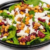 Spinach Side Salad · Fresh baby spinach, dried cranberries, candied walnuts, and aged feta. Served with one dress...