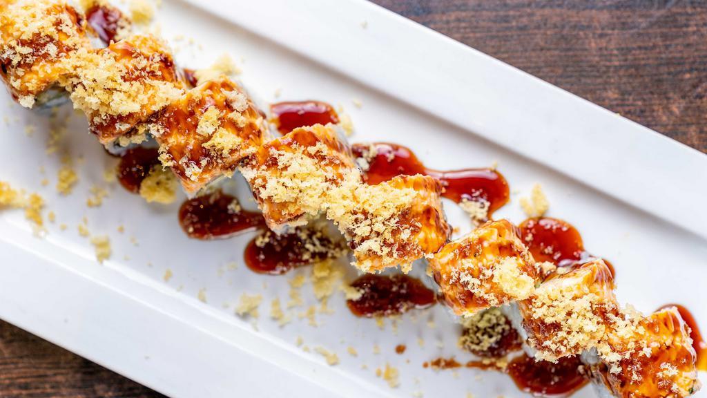 Hero Roll · Shrimp tempura, avocado, cucumber, topped with spicy crab and eel sauce.crunchies