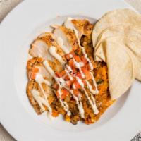 Arroz Con Pollo · House-made red rice, seasoned chicken, grilled vegetables, mushrooms, arbol salsa, and chedd...