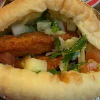 Schnitzel Pita · Breaded chicken deep fried in a pita with hummus, salad, hot sauce, and tahini sauce.