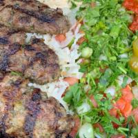 Kabob Plate · Four juicy kabobs grilled with onions and parsley and added to a plate with rice, hummus, yo...
