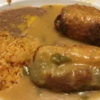 Chile Relleno Plate · 2 rellenos stuffed with cheese, smothered with red or green chile, Spanish rice, refried bea...