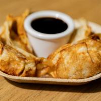 Chicken Gyoza (6) · Six pieces of our chicken gyoza served with house sesame sauce.